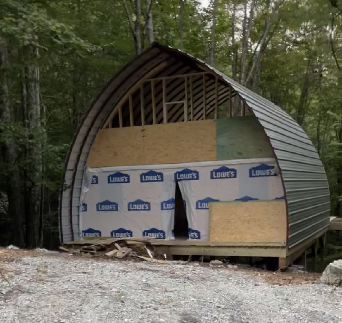 Exterior front — half-built Quonset cabin, partially wrapped, Beech Mountain NC