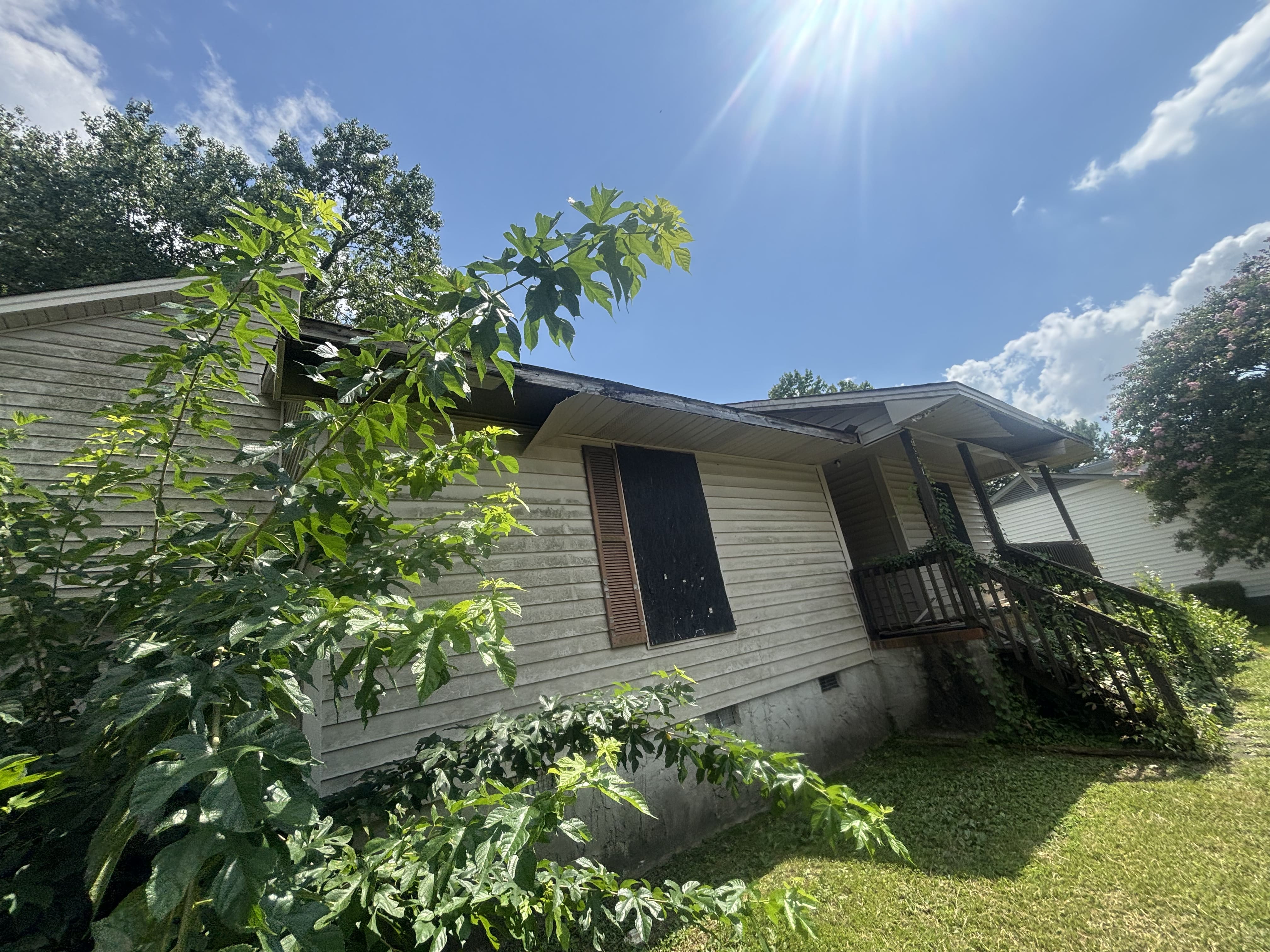 Exterior front — heavily overgrown, Fayetteville NC