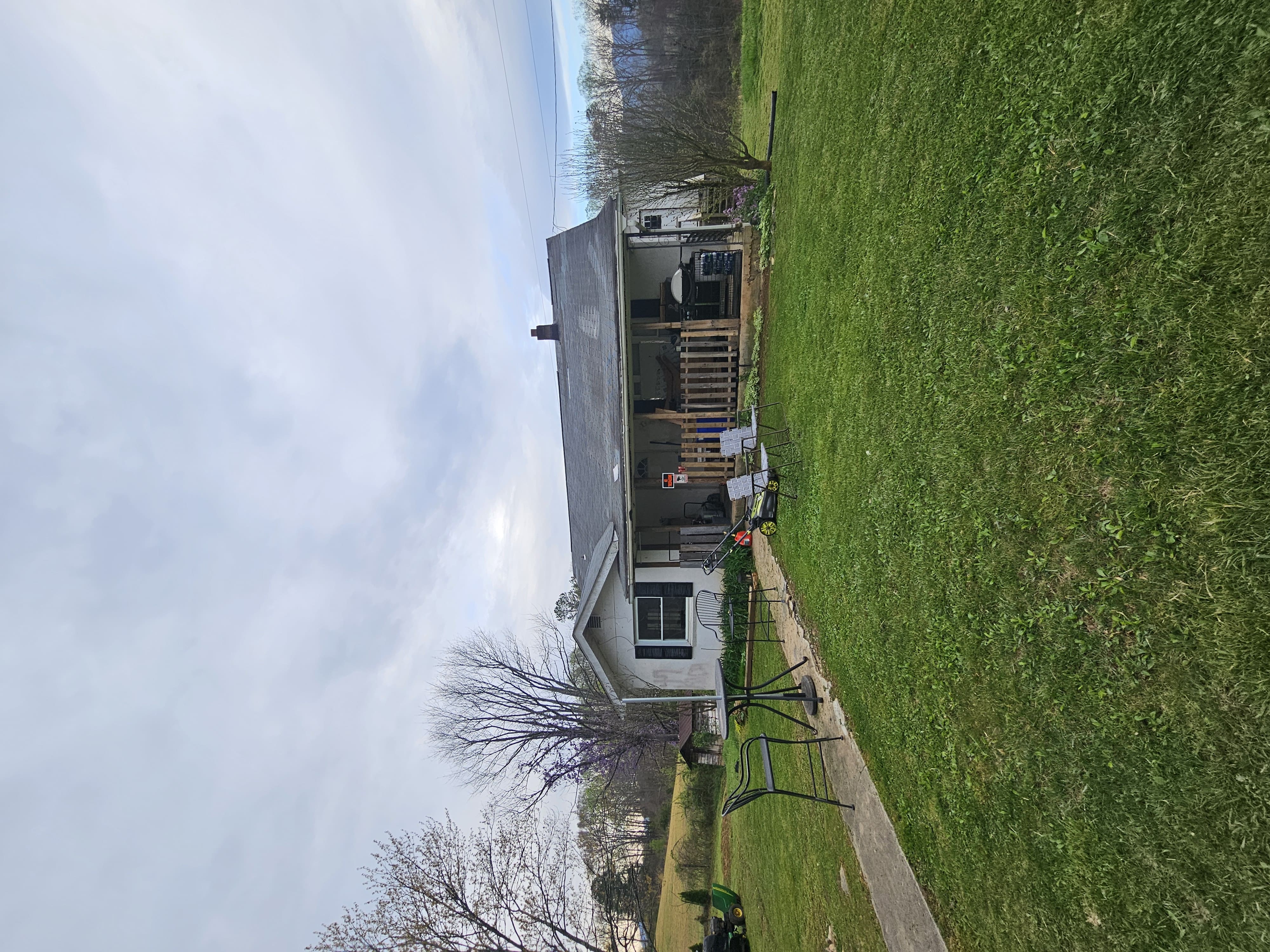Porch area — squatter belongings visible, Leicester NC
