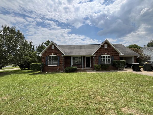 Exterior front view — wide lot, well-maintained landscaping, Monroe NC