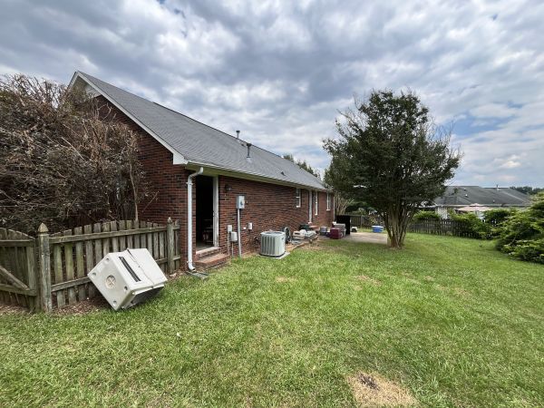 Exterior rear — fenced backyard, mature trees, Monroe NC