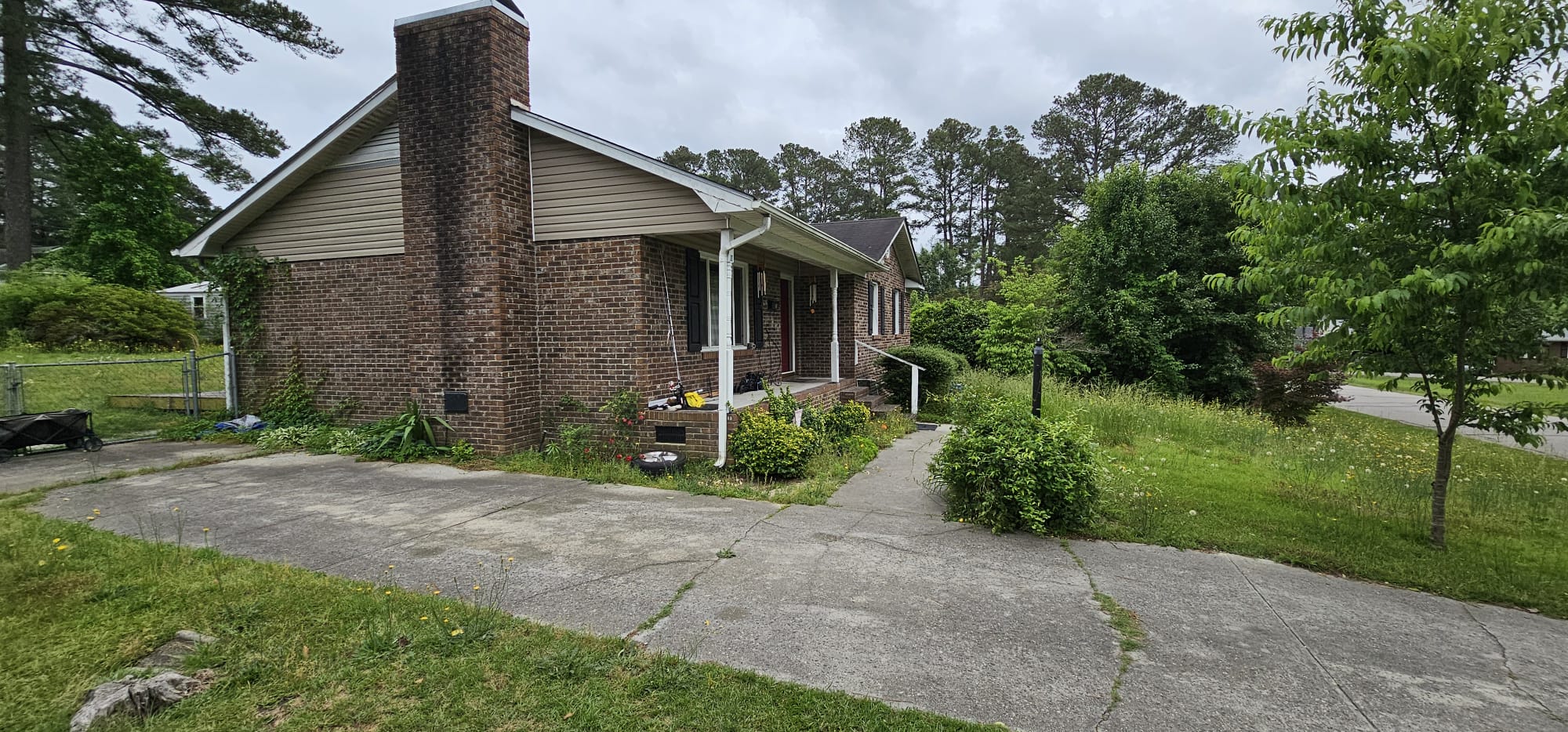 Exterior side — brick chimney, driveway, Rockingham NC