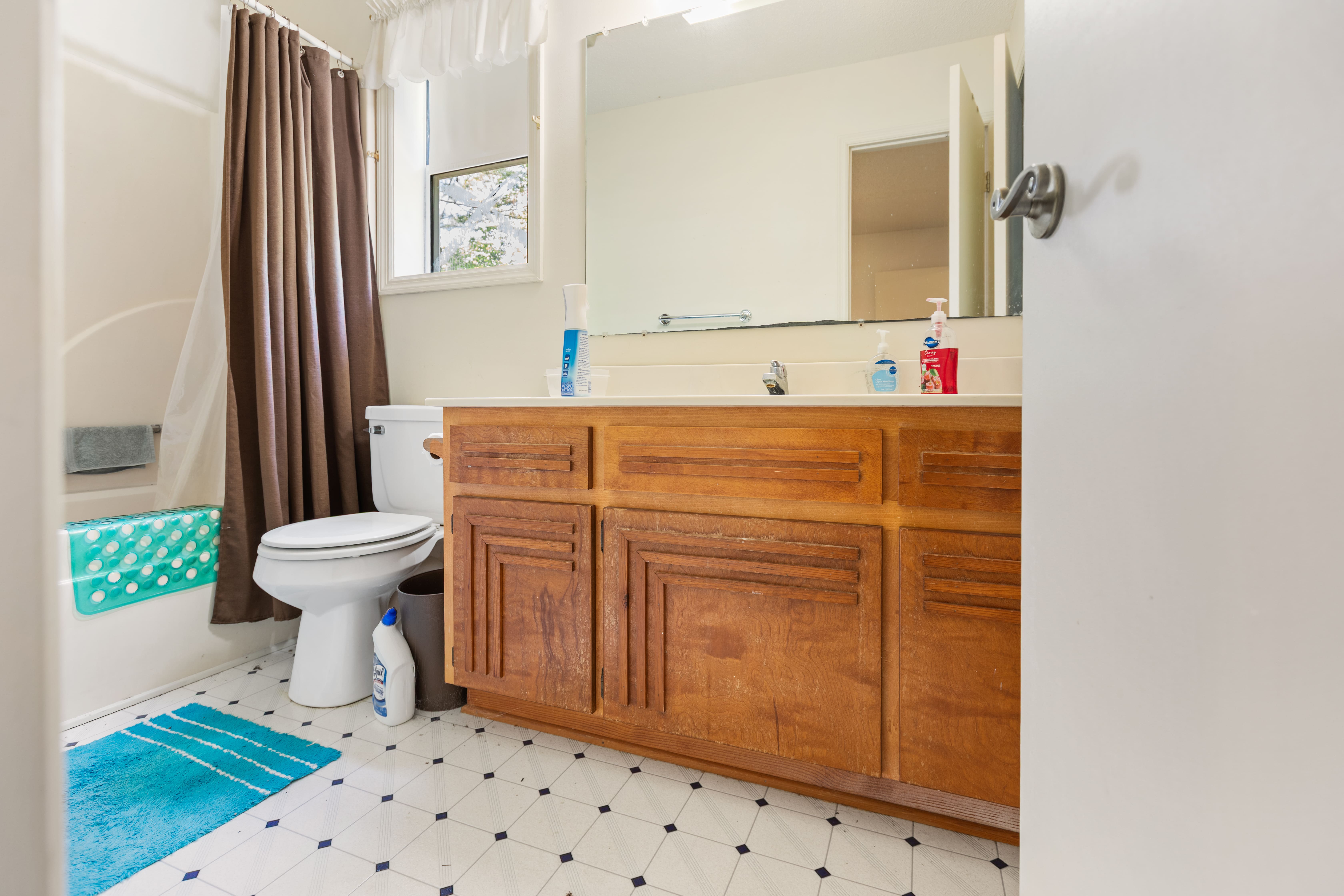Bathroom — dated cabinetry, original tile, Swansboro NC