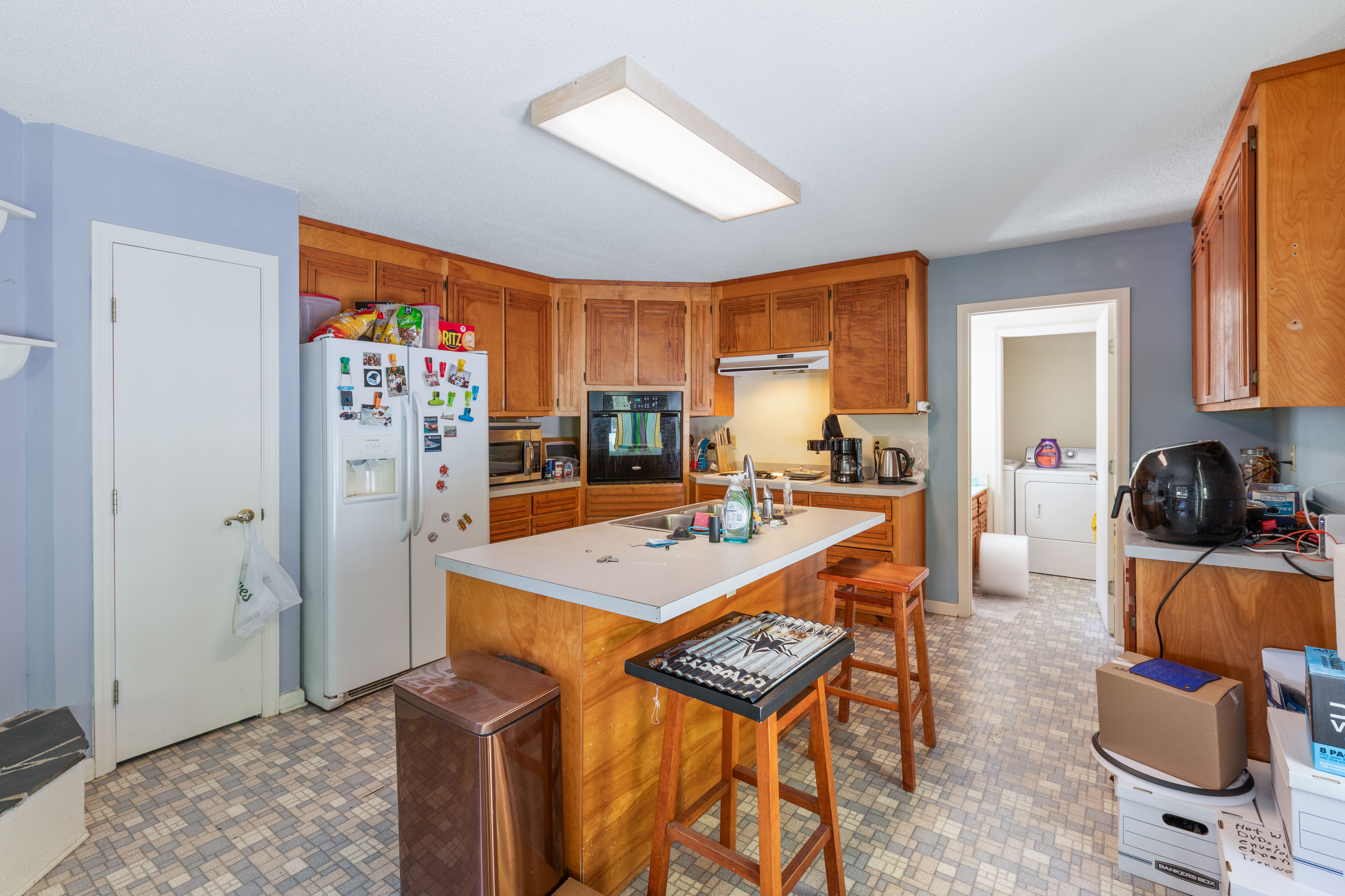 Kitchen with island seating and laundry room — Swansboro NC