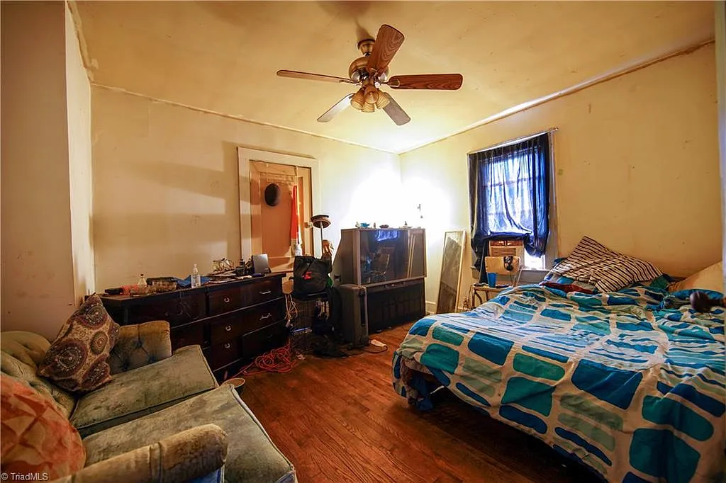 Second bedroom — occupied, original wood floors, Winston-Salem NC
